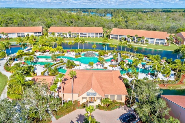 6810 Beach Resort Dr Unit 13, Naples, FL 34114 - aerial view of a pool area, a heavily wooded area, and a nearby body of water