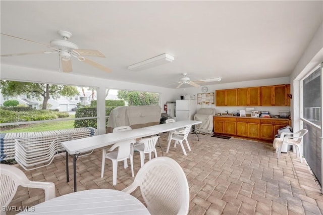 2141 Tama Cir Unit 202, Naples, FL 34112 - sunroom with outdoor dining space and ceiling fan
