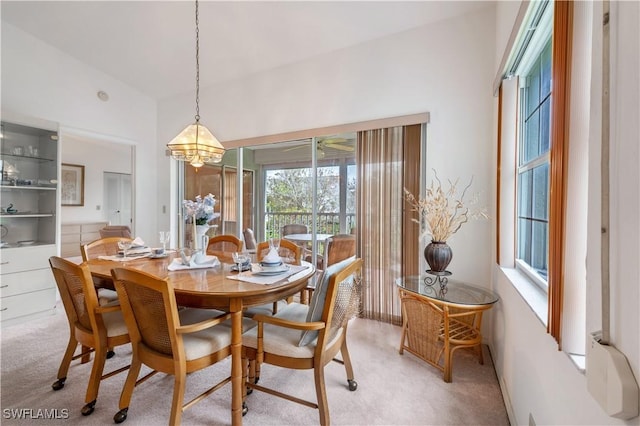 2141 Tama Cir Unit 202, Naples, FL 34112 - dining room featuring light carpet and a chandelier