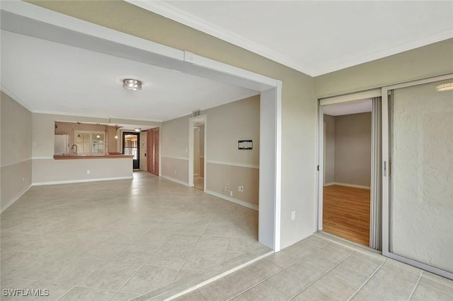 1051 Foxfire Ln Unit 309, Naples, FL 34104 - unfurnished living room featuring light tile patterned floors, crown molding, and baseboards