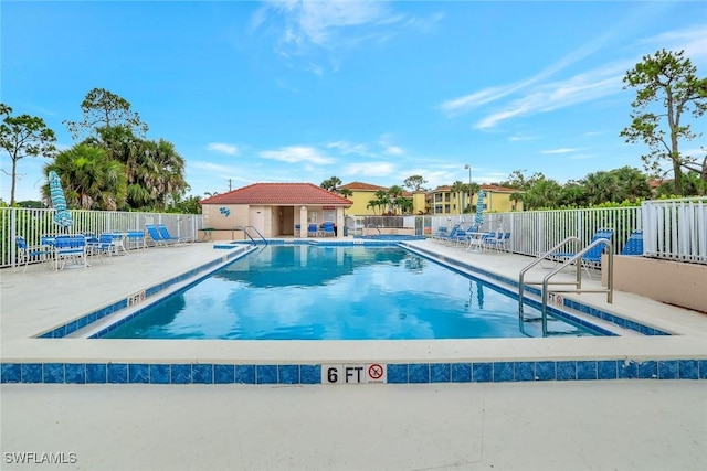 1051 Foxfire Ln Unit 309, Naples, FL 34104 - community pool with a patio area