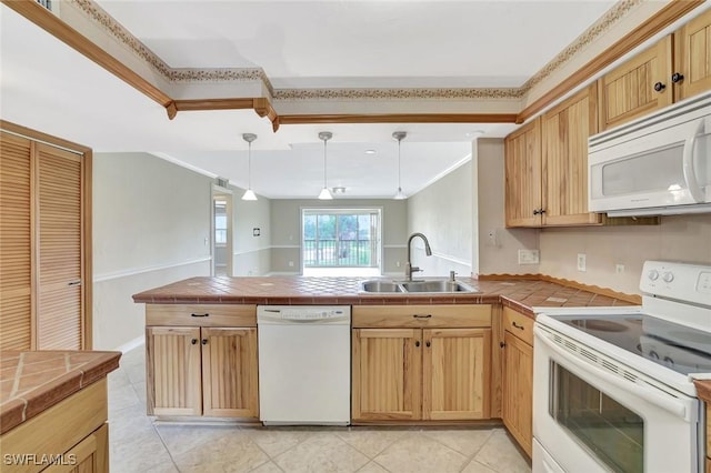 1051 Foxfire Ln Unit 309, Naples, FL 34104 - kitchen with white appliances, a sink, tile counters, a peninsula, and light tile patterned floors