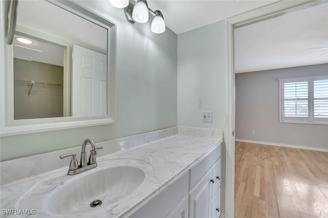 1051 Foxfire Ln Unit 309, Naples, FL 34104 - bathroom with vanity, wood finished floors, and baseboards