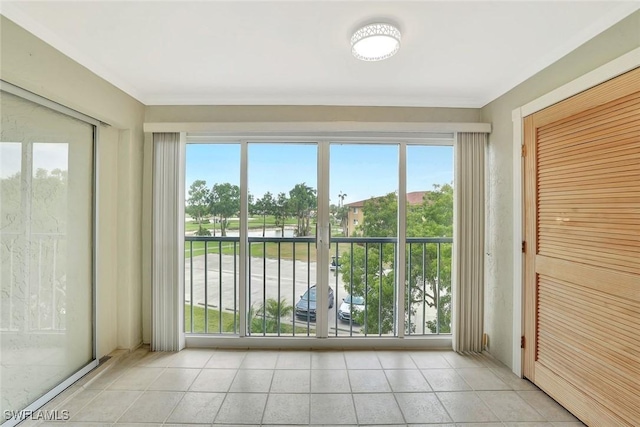 1051 Foxfire Ln Unit 309, Naples, FL 34104 - doorway to outside with plenty of natural light, tile patterned flooring, and ornamental molding