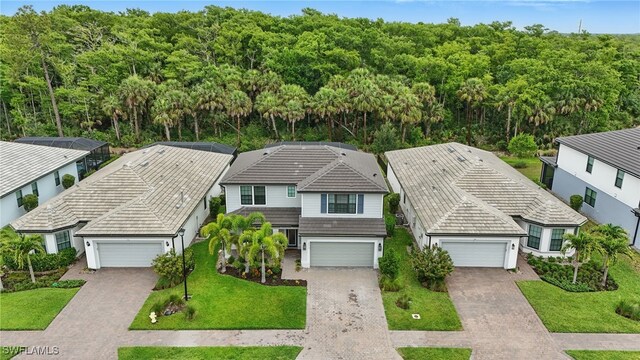 10415 Ventana Ln, Naples, FL 34120 - view from above of property with a heavily wooded area