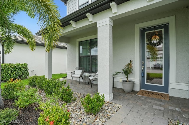 10415 Ventana Ln, Naples, FL 34120 - property entrance with covered porch and stucco siding