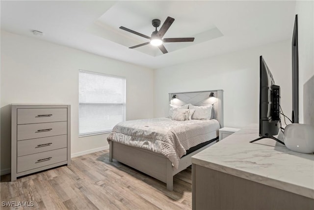 27130 Savoy Dr, Punta Gorda, FL 33955 - bedroom featuring a raised ceiling, light wood finished floors, baseboards, and ceiling fan