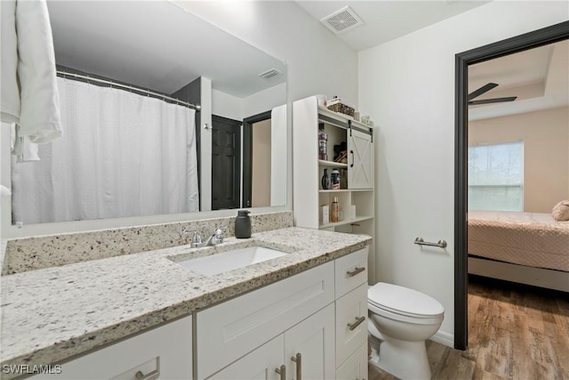 27130 Savoy Dr, Punta Gorda, FL 33955 - bathroom with wood finished floors, vanity, toilet, and ensuite bathroom