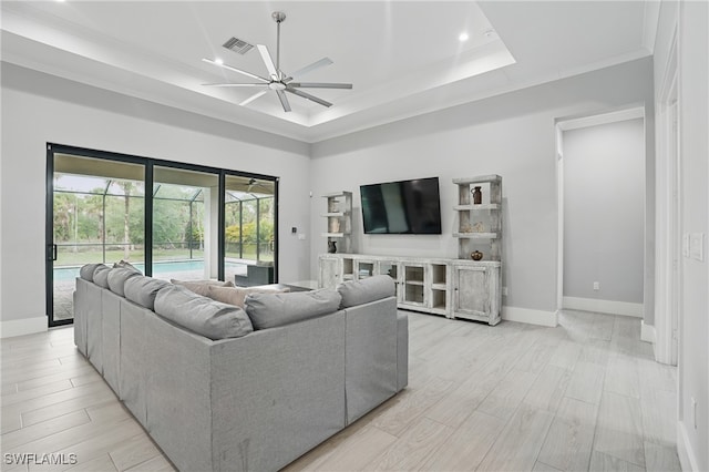 505 7th St NW, Naples, FL 34120 - living area featuring ceiling fan, a raised ceiling, baseboards, light wood finished floors, and a sunroom
