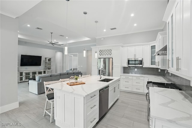 505 7th St NW, Naples, FL 34120 - kitchen featuring appliances with stainless steel finishes, a sink, open floor plan, recessed lighting, and decorative backsplash