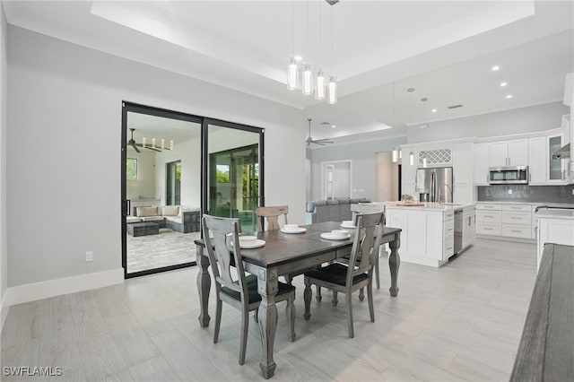 505 7th St NW, Naples, FL 34120 - dining space with a raised ceiling, recessed lighting, a chandelier, ornamental molding, and light wood-style flooring