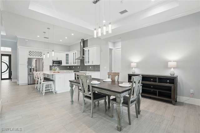 505 7th St NW, Naples, FL 34120 - dining area with a raised ceiling, crown molding, baseboards, light wood finished floors, and recessed lighting