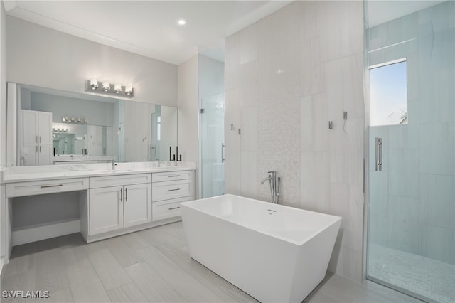 505 7th St NW, Naples, FL 34120 - full bathroom with a stall shower, a freestanding tub, and vanity