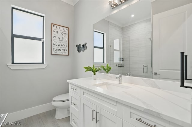 505 7th St NW, Naples, FL 34120 - bathroom with toilet, baseboards, vanity, and a shower stall