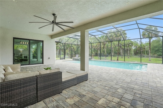 505 7th St NW, Naples, FL 34120 - view of swimming pool featuring an outdoor living space, a patio, a ceiling fan, a pool with connected hot tub, and glass enclosure