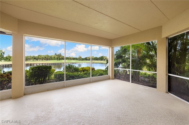 1880 Les Chateaux Blvd Unit 104, Naples, FL 34109 - unfurnished sunroom with a water view and a textured wall
