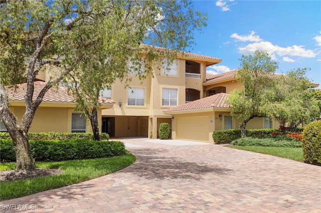 1880 Les Chateaux Blvd Unit 104, Naples, FL 34109 - view of front facade with decorative driveway, a tile roof, stucco siding, and a garage