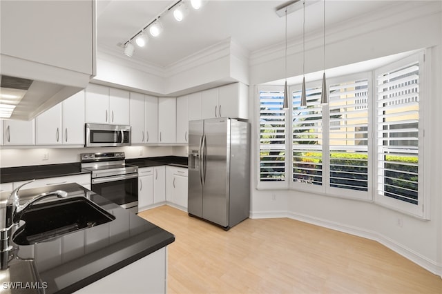 1880 Les Chateaux Blvd Unit 104, Naples, FL 34109 - kitchen featuring appliances with stainless steel finishes, dark countertops, track lighting, plenty of natural light, and crown molding
