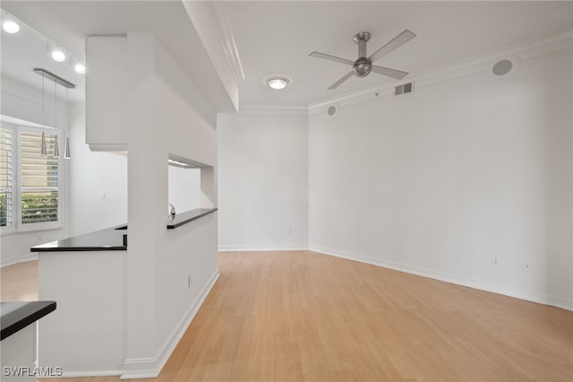 1880 Les Chateaux Blvd Unit 104, Naples, FL 34109 - empty room featuring crown molding, light wood-type flooring, and ceiling fan
