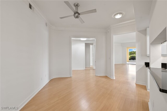 1880 Les Chateaux Blvd Unit 104, Naples, FL 34109 - unfurnished room featuring light wood-style floors, ceiling fan, and crown molding