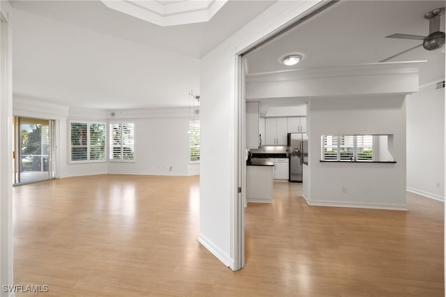 1880 Les Chateaux Blvd Unit 104, Naples, FL 34109 - unfurnished living room with light wood-style flooring, ceiling fan, and crown molding