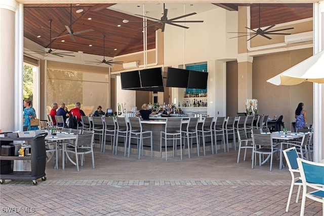 1880 Les Chateaux Blvd Unit 104, Naples, FL 34109 - view of patio with ceiling fan, an AC wall unit, and a bar
