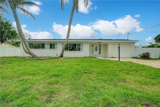 32 Fairview Blvd, Fort Myers Beach, FL 33931 - back of property featuring stucco siding, driveway, and an attached garage