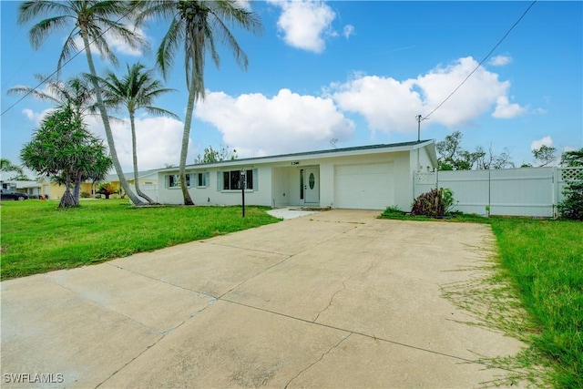 32 Fairview Blvd, Fort Myers Beach, FL 33931 - ranch-style home featuring an attached garage, driveway, and stucco siding