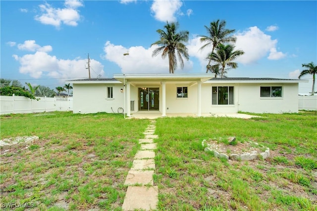 32 Fairview Blvd, Fort Myers Beach, FL 33931 - back of property with stucco siding and a patio area