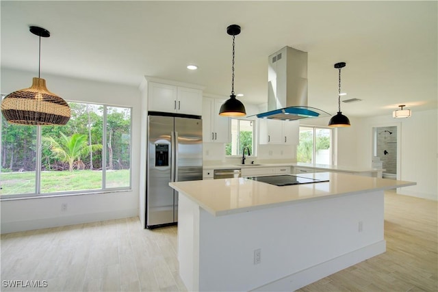 32 Fairview Blvd, Fort Myers Beach, FL 33931 - kitchen with stainless steel appliances, island range hood, a sink, light countertops, and recessed lighting