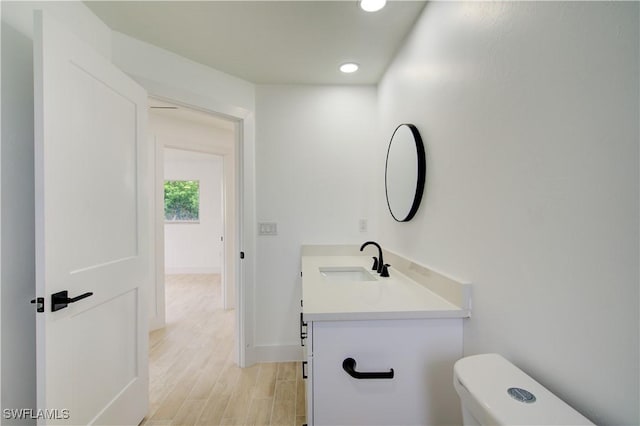 32 Fairview Blvd, Fort Myers Beach, FL 33931 - bathroom featuring vanity, toilet, recessed lighting, baseboards, and wood finished floors