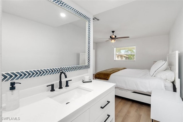 4126 Belair Ln Unit C6, Naples, FL 34103 - bedroom featuring a sink, wood finished floors, and a ceiling fan