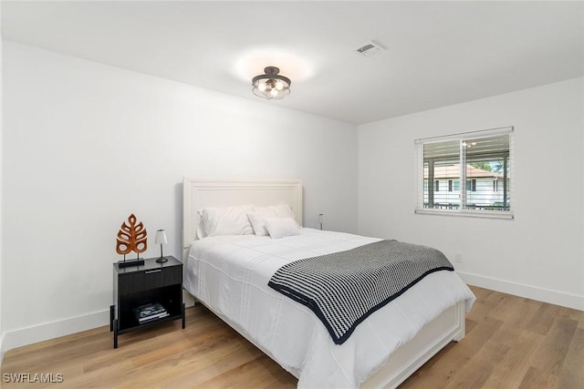 4126 Belair Ln Unit C6, Naples, FL 34103 - bedroom with light wood-style flooring and baseboards