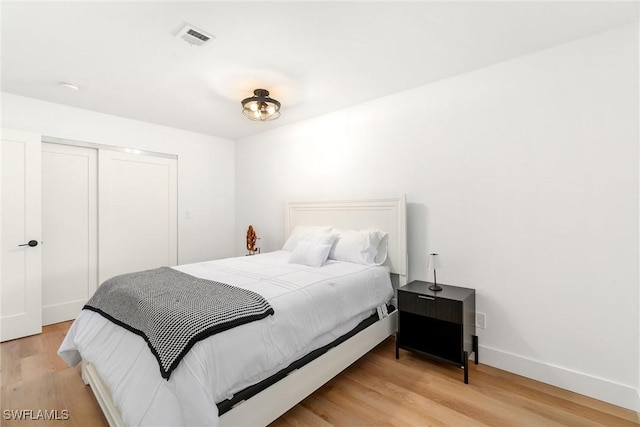 4126 Belair Ln Unit C6, Naples, FL 34103 - bedroom featuring light wood-style flooring, a closet, and baseboards