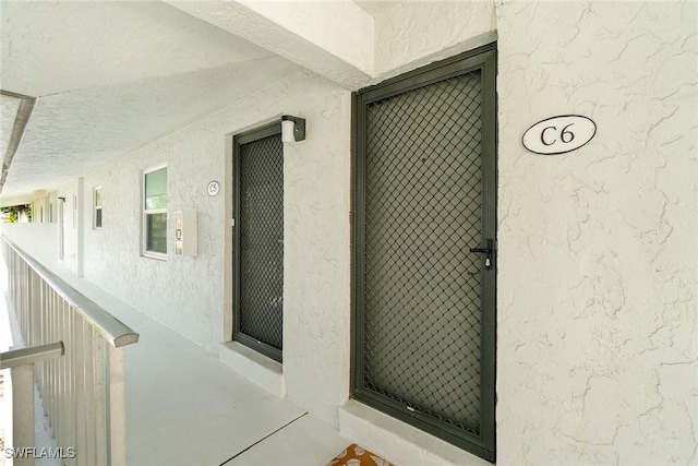 4126 Belair Ln Unit C6, Naples, FL 34103 - view of exterior entry featuring stucco siding