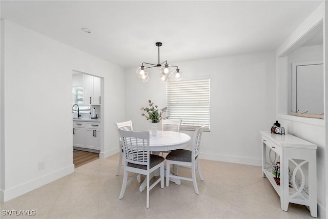 4126 Belair Ln Unit C6, Naples, FL 34103 - dining space featuring a chandelier, baseboards, and light tile patterned floors