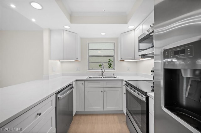 1549 Sandpiper St Unit 59, Naples, FL 34102 - kitchen featuring stainless steel appliances, a sink, crown molding, recessed lighting, and light countertops