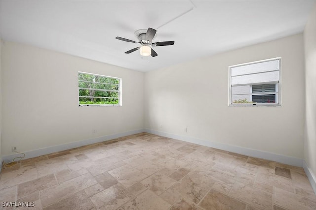 1549 Sandpiper St Unit 59, Naples, FL 34102 - unfurnished room with stone tile floors, ceiling fan, and baseboards
