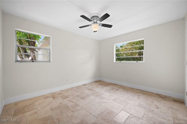 1549 Sandpiper St Unit 59, Naples, FL 34102 - spare room featuring stone tile floors, baseboards, and ceiling fan