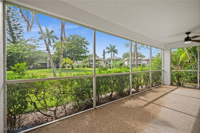 1549 Sandpiper St Unit 59, Naples, FL 34102 - unfurnished sunroom featuring a ceiling fan and a residential view
