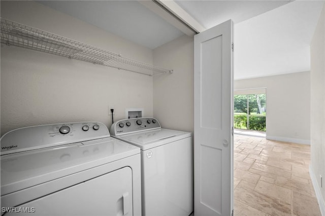 1549 Sandpiper St Unit 59, Naples, FL 34102 - laundry area with washer and dryer, stone tile floors, and baseboards