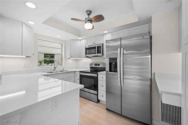 1549 Sandpiper St Unit 59, Naples, FL 34102 - kitchen featuring appliances with stainless steel finishes, a sink, a raised ceiling, light countertops, and recessed lighting