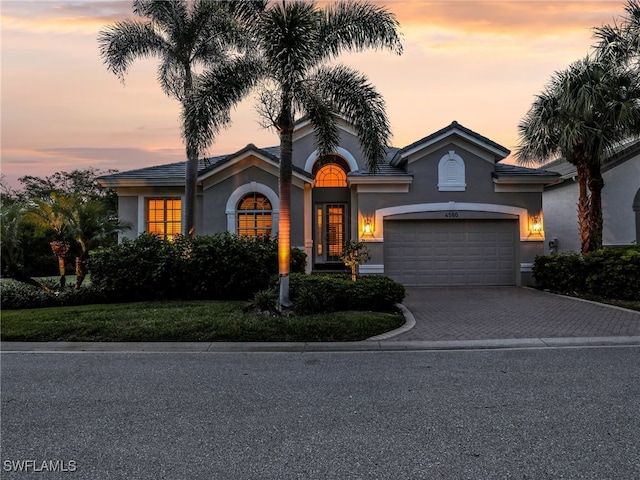 4580 Shell Ridge Ct, Bonita Springs, FL 34134 - view of front of property featuring stucco siding, an attached garage, and driveway
