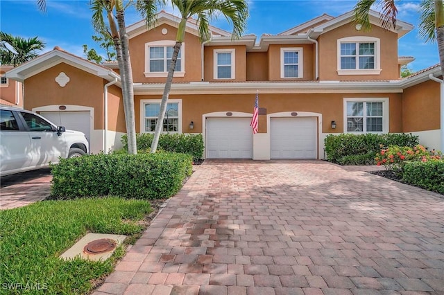 18273 Creekside Preserve Loop Unit 101, Fort Myers, FL 33908 - townhome / multi-family property with stucco siding, decorative driveway, and an attached garage