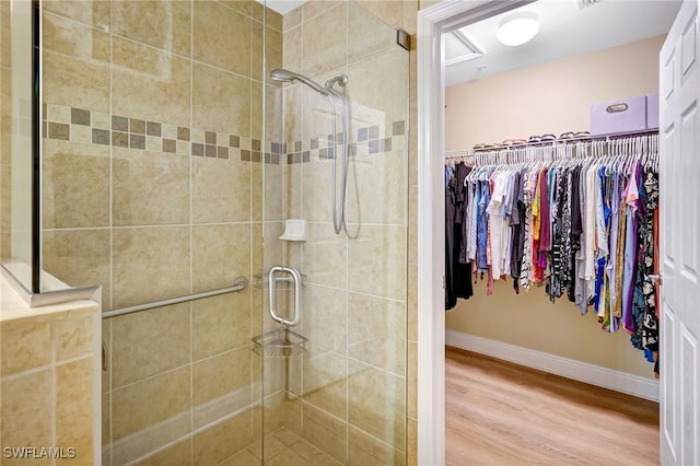 18273 Creekside Preserve Loop Unit 101, Fort Myers, FL 33908 - full bath with wood finished floors, a shower stall, and a walk in closet