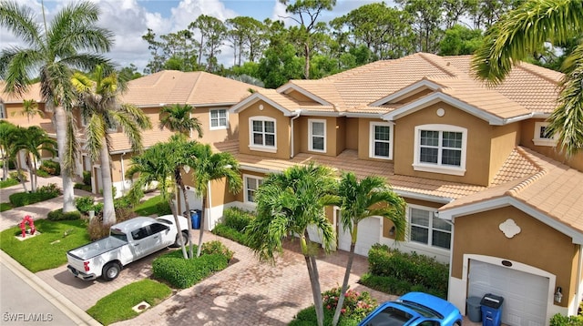 18273 Creekside Preserve Loop Unit 101, Fort Myers, FL 33908 - view of property featuring stucco siding, a tile roof, and decorative driveway