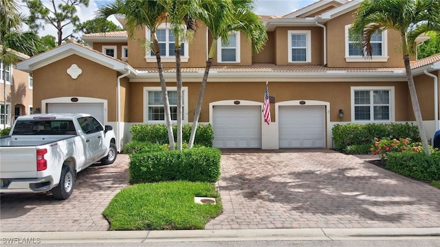 18273 Creekside Preserve Loop Unit 101, Fort Myers, FL 33908 - townhome / multi-family property featuring stucco siding, a garage, decorative driveway, and a tile roof