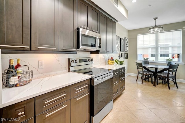 18273 Creekside Preserve Loop Unit 101, Fort Myers, FL 33908 - kitchen featuring stainless steel appliances, dark brown cabinetry, and decorative backsplash