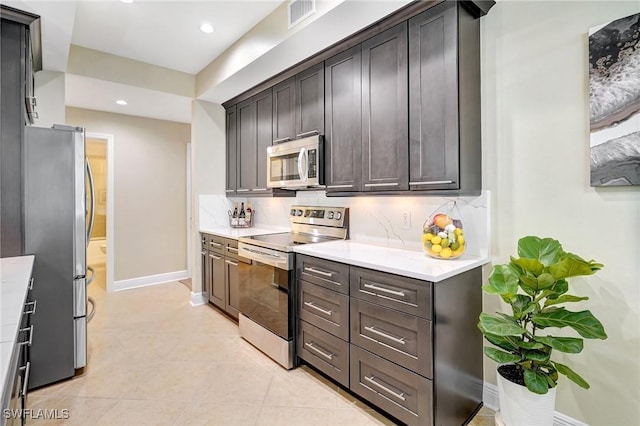 18273 Creekside Preserve Loop Unit 101, Fort Myers, FL 33908 - kitchen with appliances with stainless steel finishes, light countertops, decorative backsplash, recessed lighting, and light tile patterned flooring