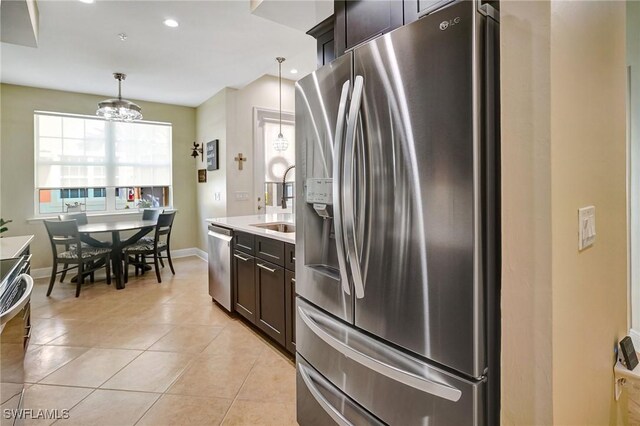 18273 Creekside Preserve Loop Unit 101, Fort Myers, FL 33908 - kitchen with stainless steel appliances, dark brown cabinetry, healthy amount of natural light, light tile patterned flooring, and recessed lighting